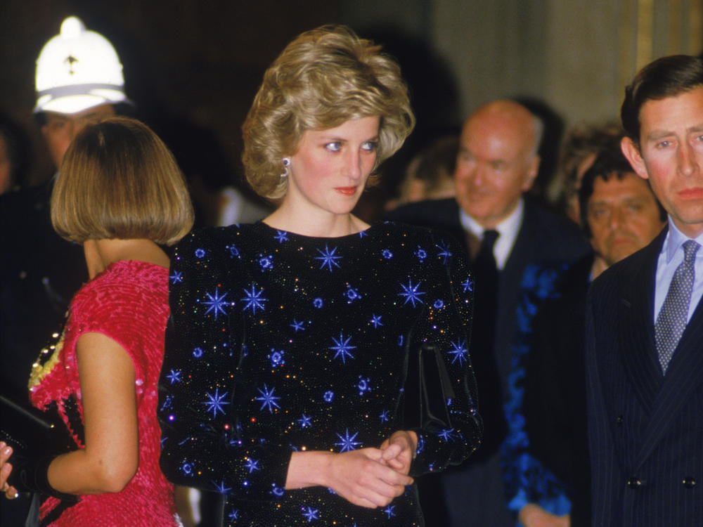 The Prince and Princess of Wales attend a dinner held by the Mayor of Florence during a tour of Italy, April 1985. The Princess wears a dress by Jacques Azagury.