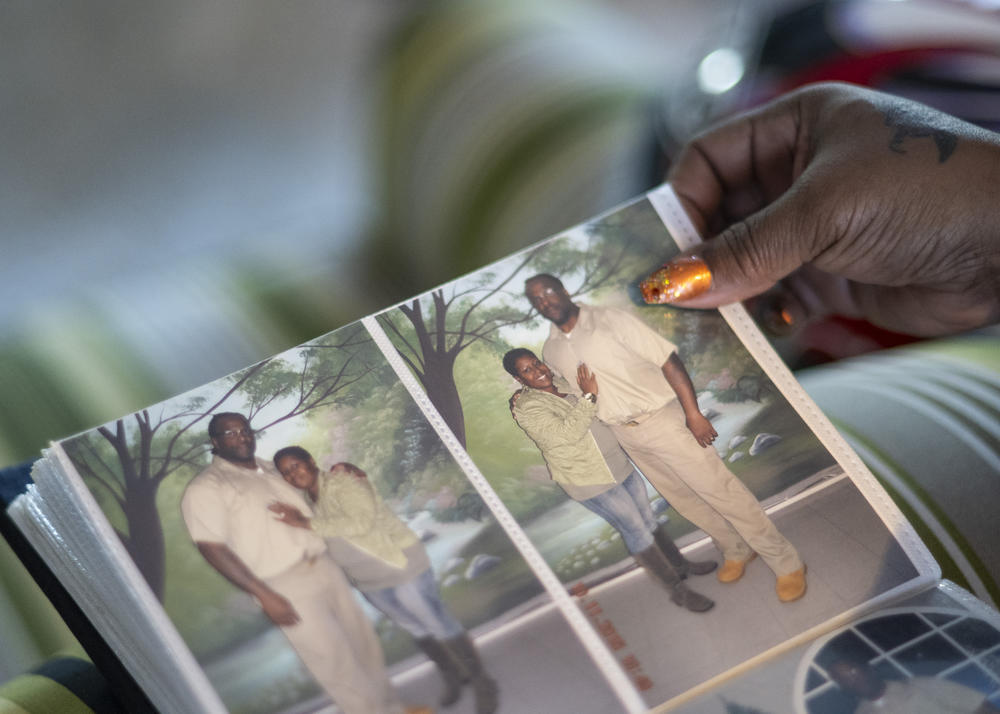 Jackson looks through a family photo album from visits to her late husband, John Jackson, while he was in prison.