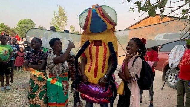 Don't worry, this six-foot-tall tsetse fly didn't bite anyone. He was part of a performance to teach Malawians about preventing sleeping sickness.