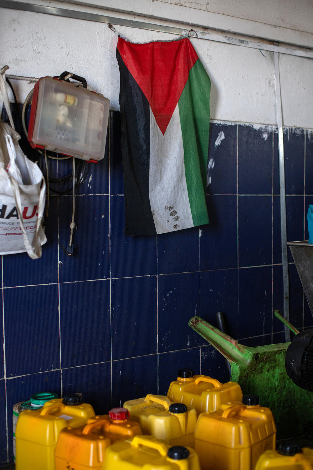 A Palestinian flag hangs at an olive pressing facility in the Palestinian village of Deir Ibzi in the occupied West Bank, Dec. 2.