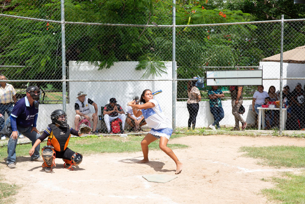 At bat, Mariela Beatriz Pacheco Pech, 31, a player on The Amazonas of Yaxunah, has her eye on the ball.