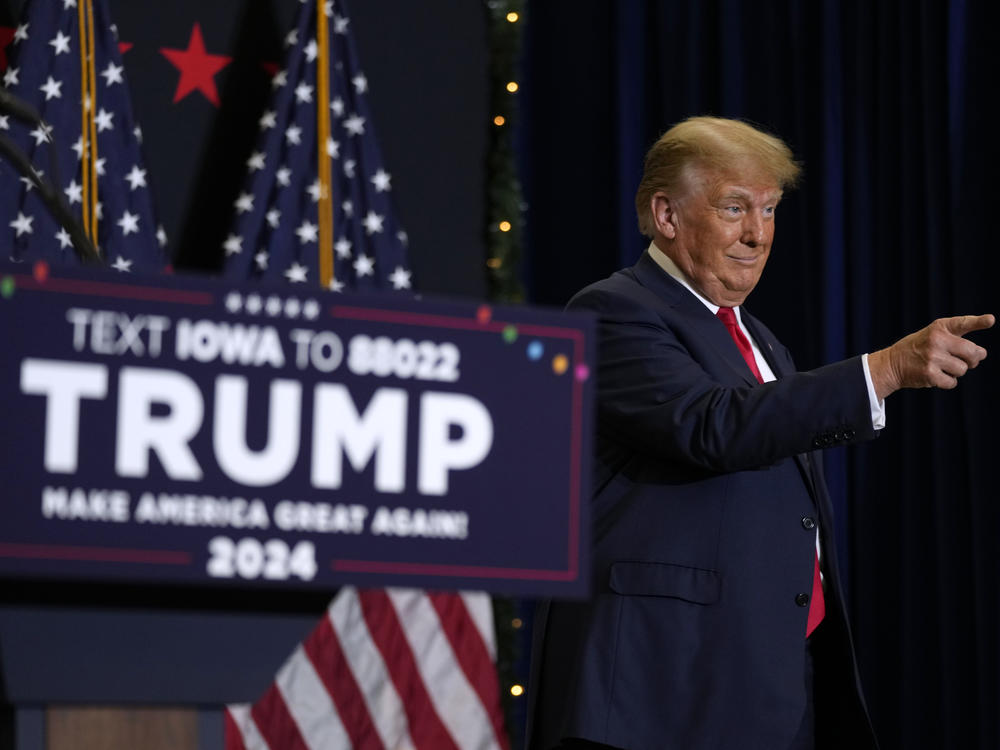 Former President Donald Trump greets supporters as he arrives at a rally on Tuesday in Waterloo, Iowa.