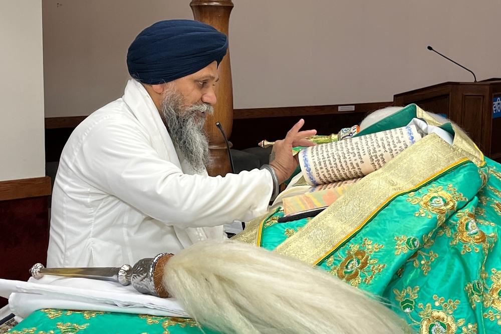 Mohkam Singh, a Sikh priest, reads the Sri Guru Granth Sahib, the Sikh holy book, at the Gurdwara Sahib temple on the outskirts of Ottawa. Canada's Sikh community is the second-largest in the world after India's.