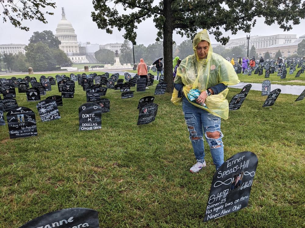 Carrie Spears lost her 23-year-old nephew, Tanner, to an overdose two years ago. She paused near a cardboard memorial marker for him at a Trail of Truth event in Washington, D.C., on Sept. 23, 2023.