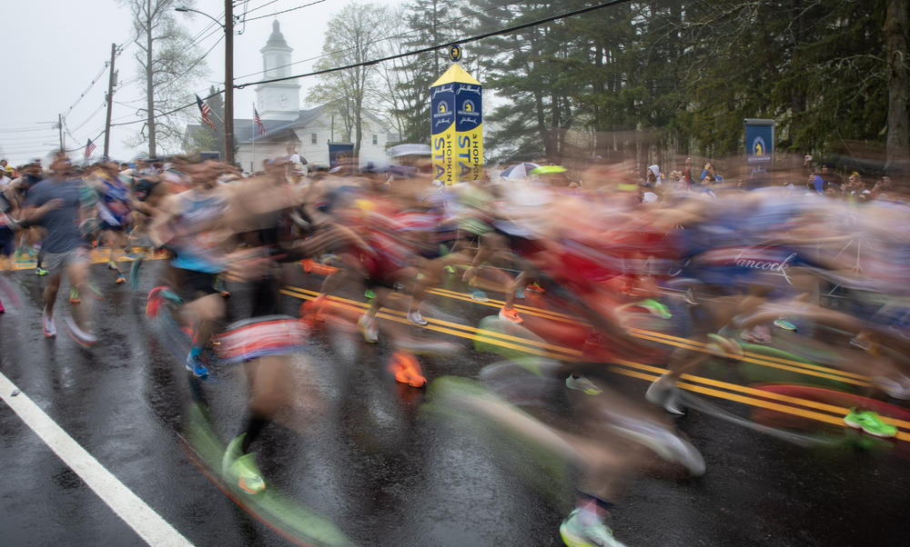 Runners cross the starting line of the 127th Boston Marathon on April 17, 2023. Full story <a href=