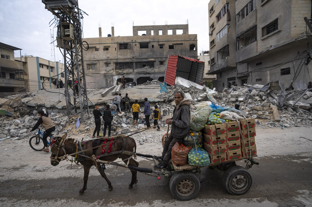 Palestinians inspect a house after it was hit by an Israeli bombardment on Rafah.