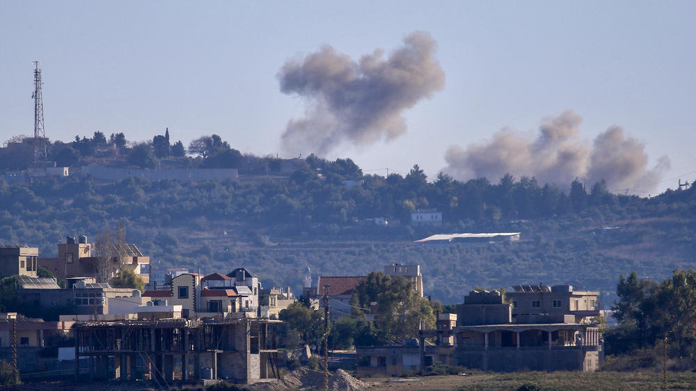 A picture taken from from the southern Lebanese village of Tayr Harfa, near the border with Israel, shows smoke billowing near an Israeli outpost from rockets fired by Hezbollah on Dec. 15.