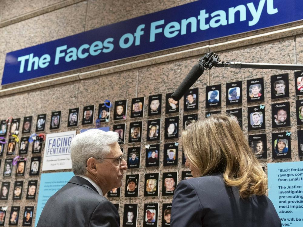 Attorney General Merrick Garland accompanied by U.S. Drug Enforcement Administration Administrator Anne Milgram, looks at photographs of people who had died from drugs during the Second Annual Family Summit on Fentanyl at DEA Headquarters in Washington, Tuesday, Sept. 26, 2023. (AP Photo/Jose Luis Magana)