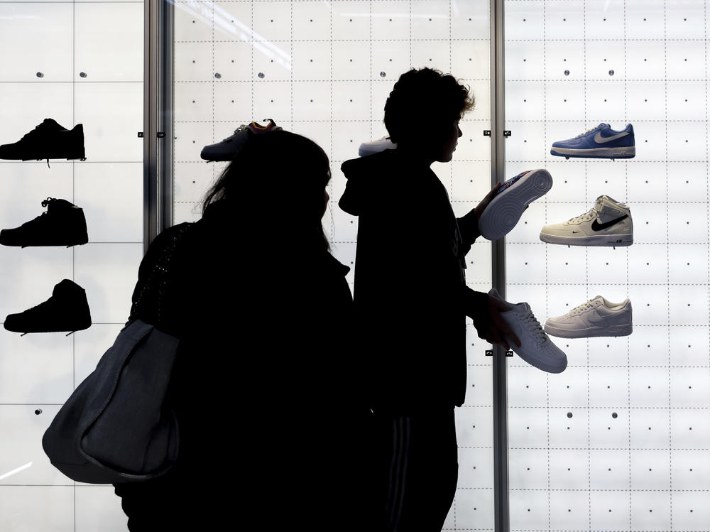 People shop for Nike shoes at a store in New York.