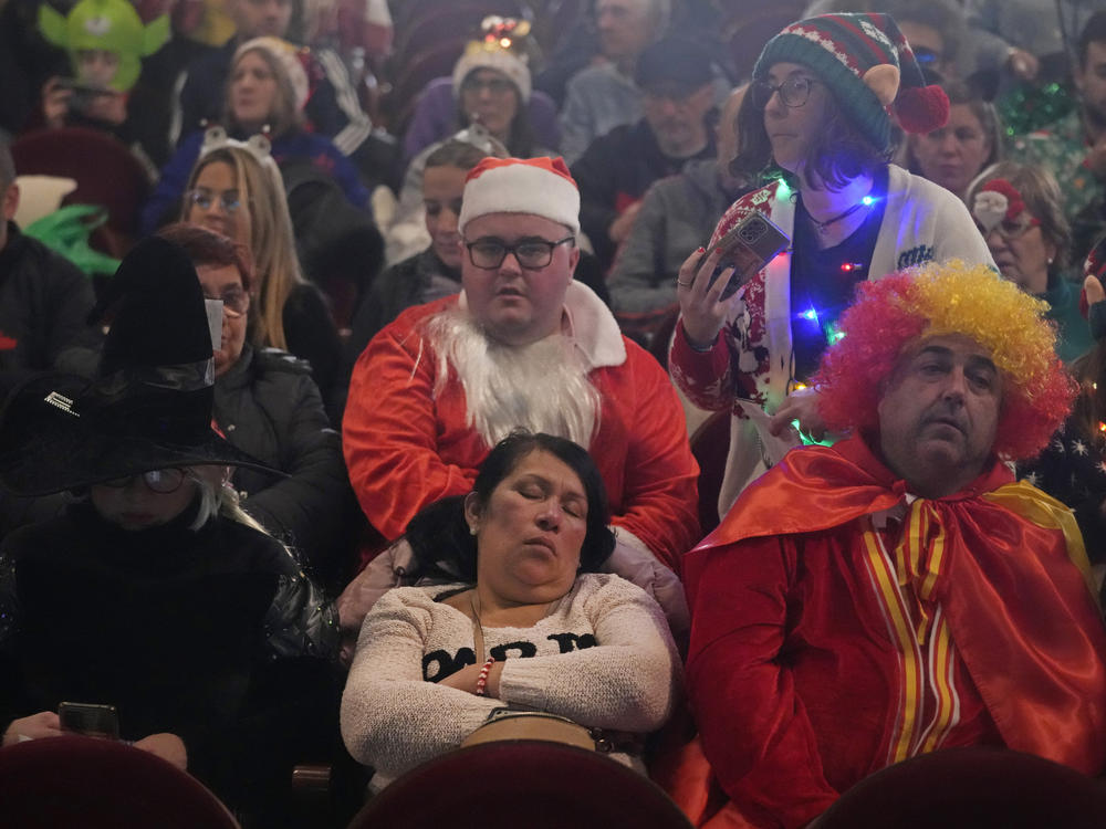 People wait for the start of the draw at Madrid's Teatro Real opera house during Spain's bumper Christmas lottery draw known as El Gordo, or The Fat One, in Madrid, Spain, Friday, Dec. 22, 2023.