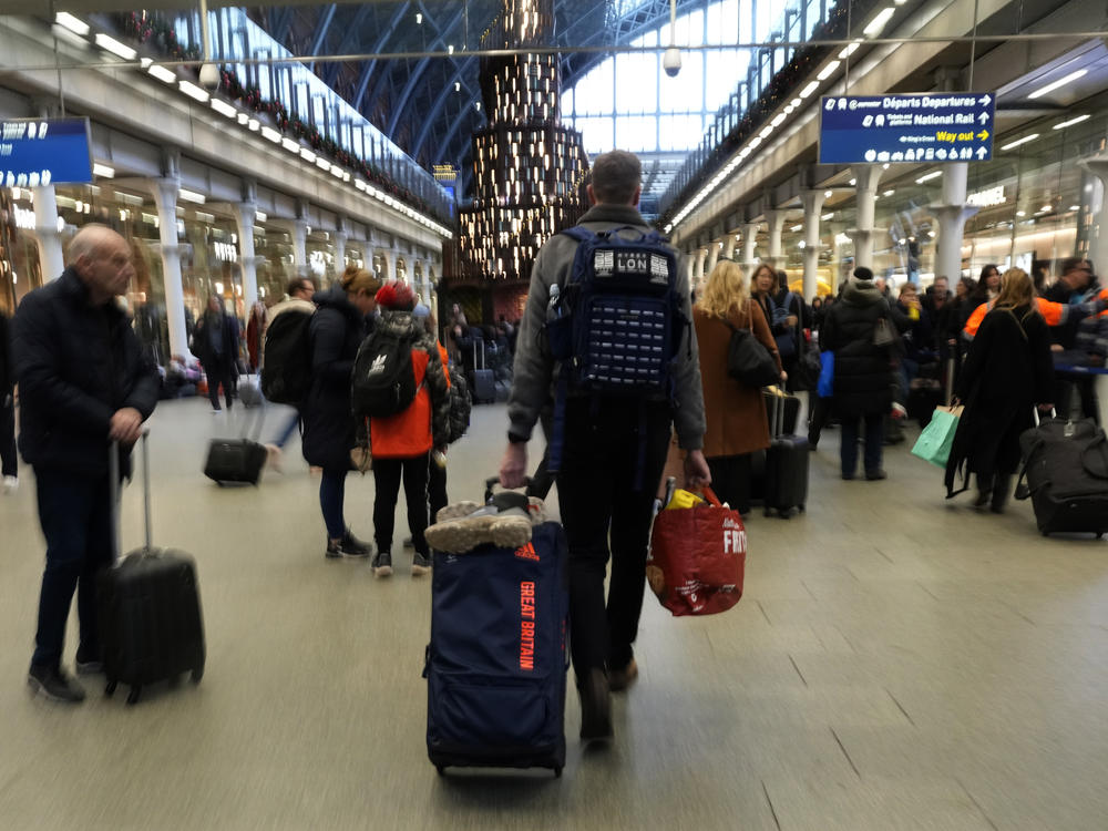 Travellers queue for the Eurostar trains at St Pancras Station in London, Friday, Dec. 22, 2023.
