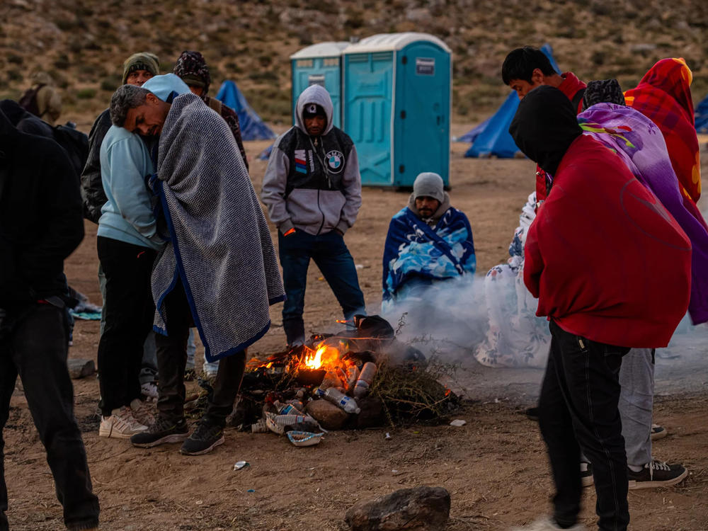 Migrants huddling for warmth at an unofficial detention camp in Jacumba, Calif. A record number of people have arrived at the southern U.S. border in the past year.