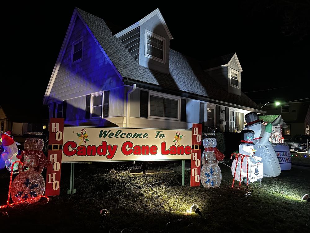 A sign greets visitors near Candy Cane Lane's entrance. About 300 homes in the Milwaukee-area neighborhood display decorations to benefit children's cancer research.