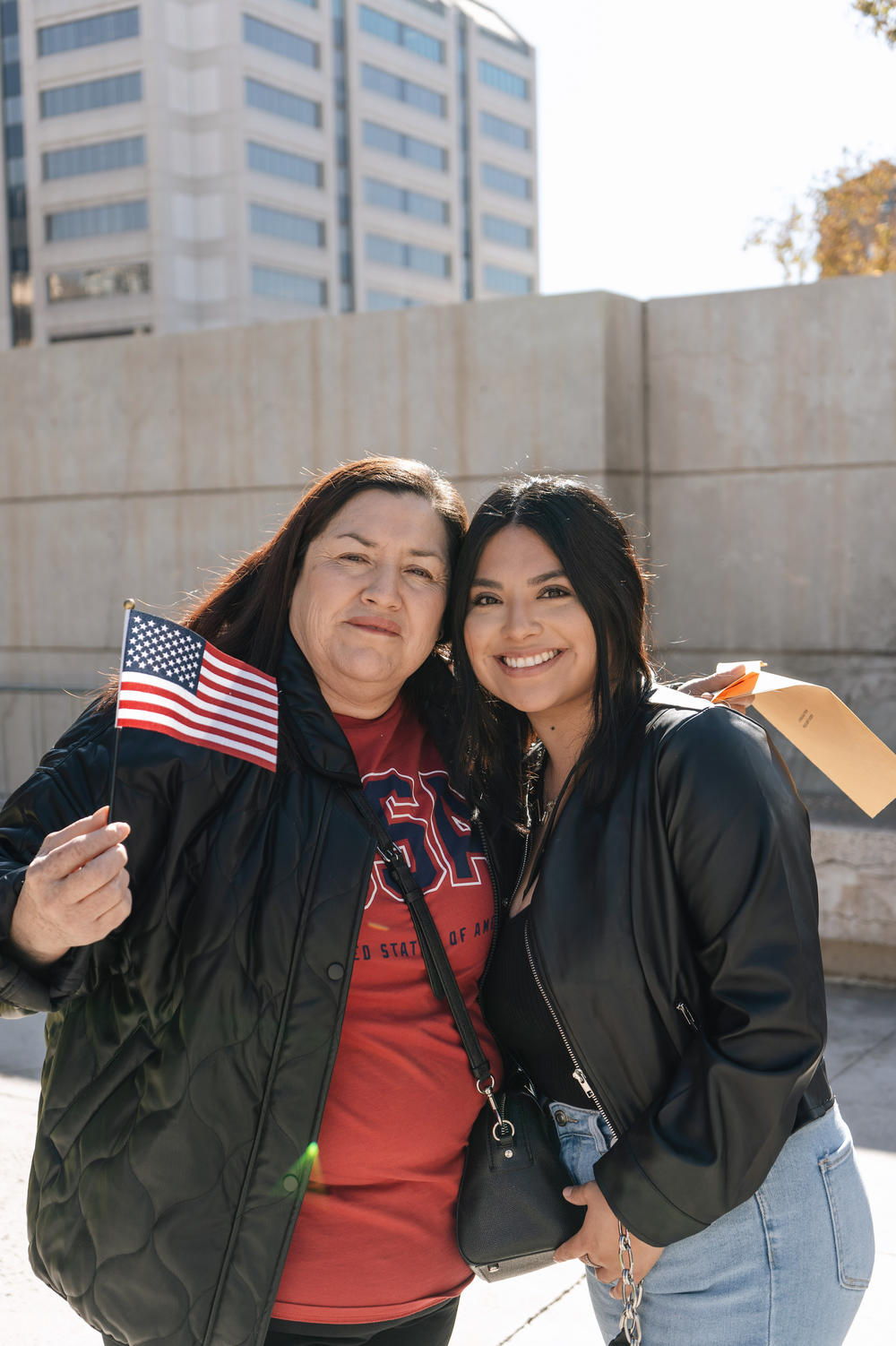 Sisters Olga Aguerra (left) and Nancy Tafolla stand outside the Sandra Day O'Connor Courthouse after Aguerra became a U.S. citizen.