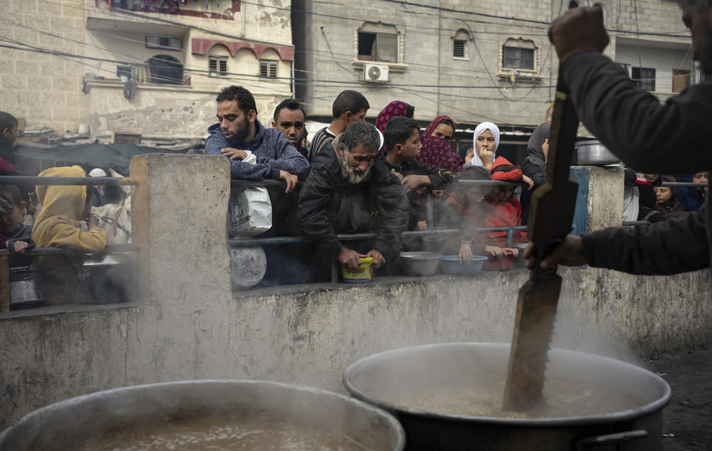 Palestinians line up for a free meal in Rafah, in southern Gaza, on Dec. 21. The war has created a humanitarian crisis in the territory. The vast majority of 2 million residents have been displaced by the fighting.