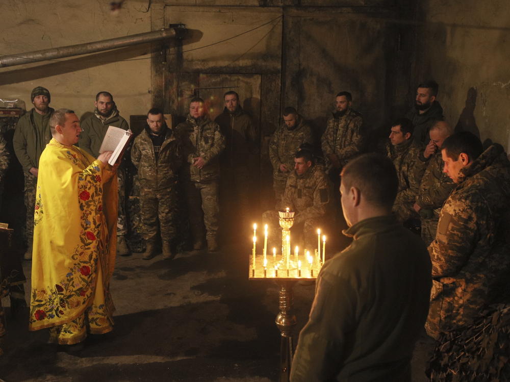 A clergyman with the Orthodox Church of Ukraine, Chaplain Ivan, conducts a liturgy for Ukrainian troops near the front line in the eastern town of Vuhledar on Dec. 15.