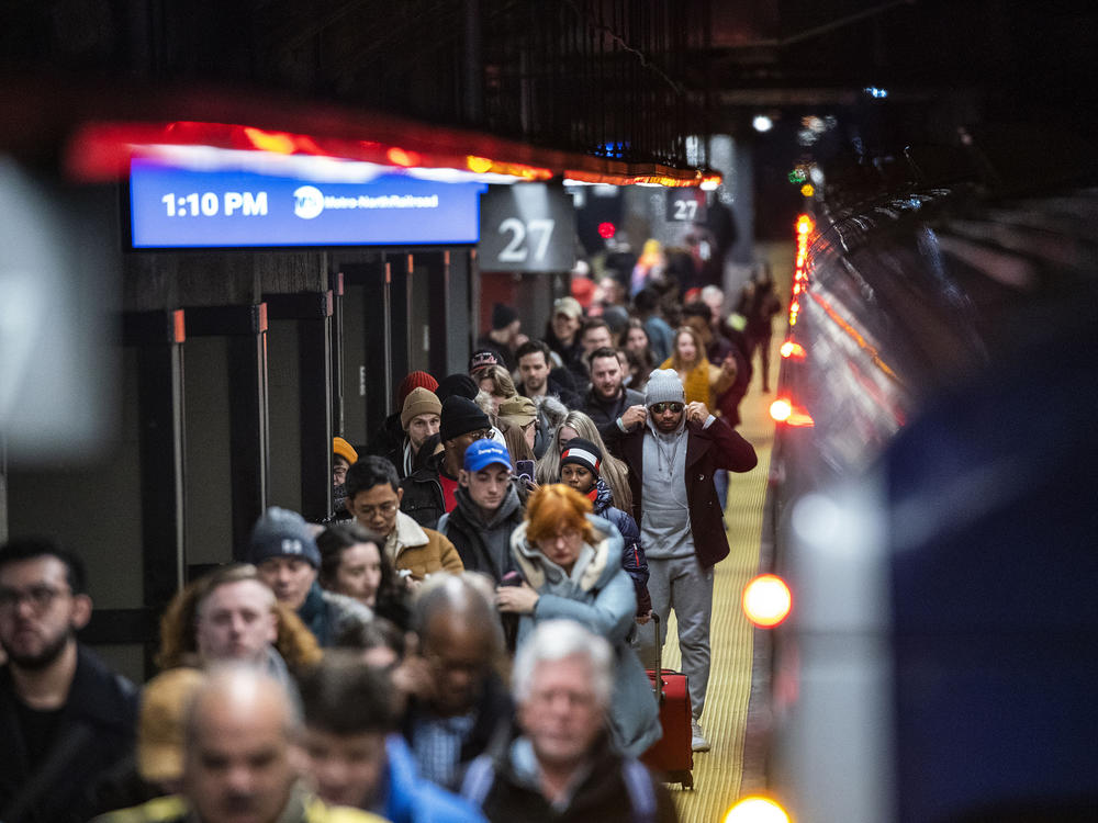 Travelers walk the ramp as they arrive to Grand Central Station in New York, Thursday, Dec. 21, 2023.