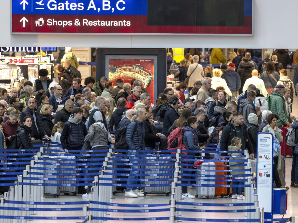 Travelers wait in the departure hall at Dusseldorf Airport, Duesseldorf, Germany, Friday Dec. 22, 2023, at the start of the Christmas vacations.