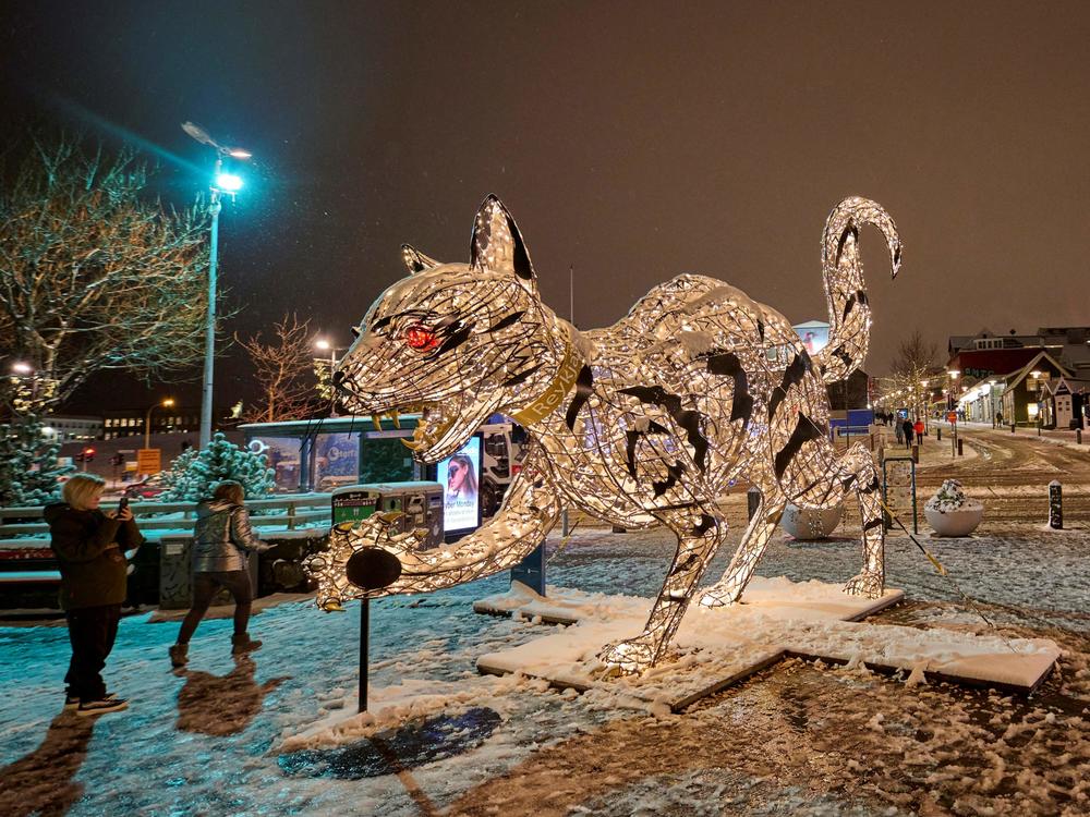 An illuminated cat sculpture in downtown Reykjavik on November 29, 2021. Icelandic folklore tells of a giant cat that eats children who don't wear their new clothes at Christmas time.