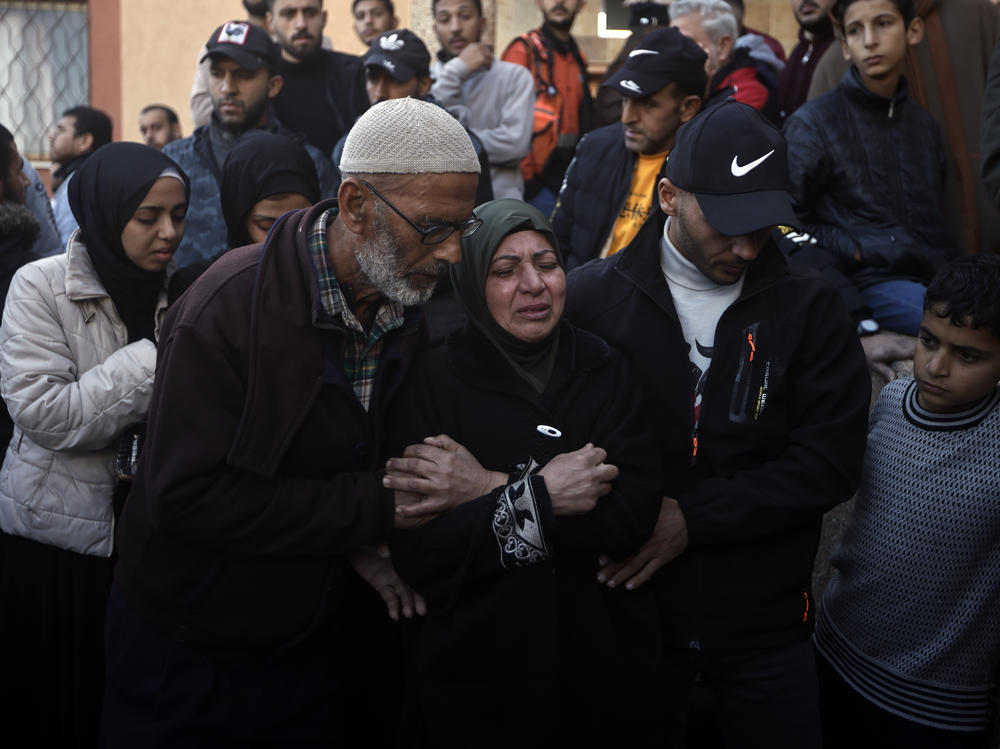 Palestinians mourn relatives killed in the Israeli bombardment of the Gaza Strip outside a morgue in Khan Younis on Sunday.