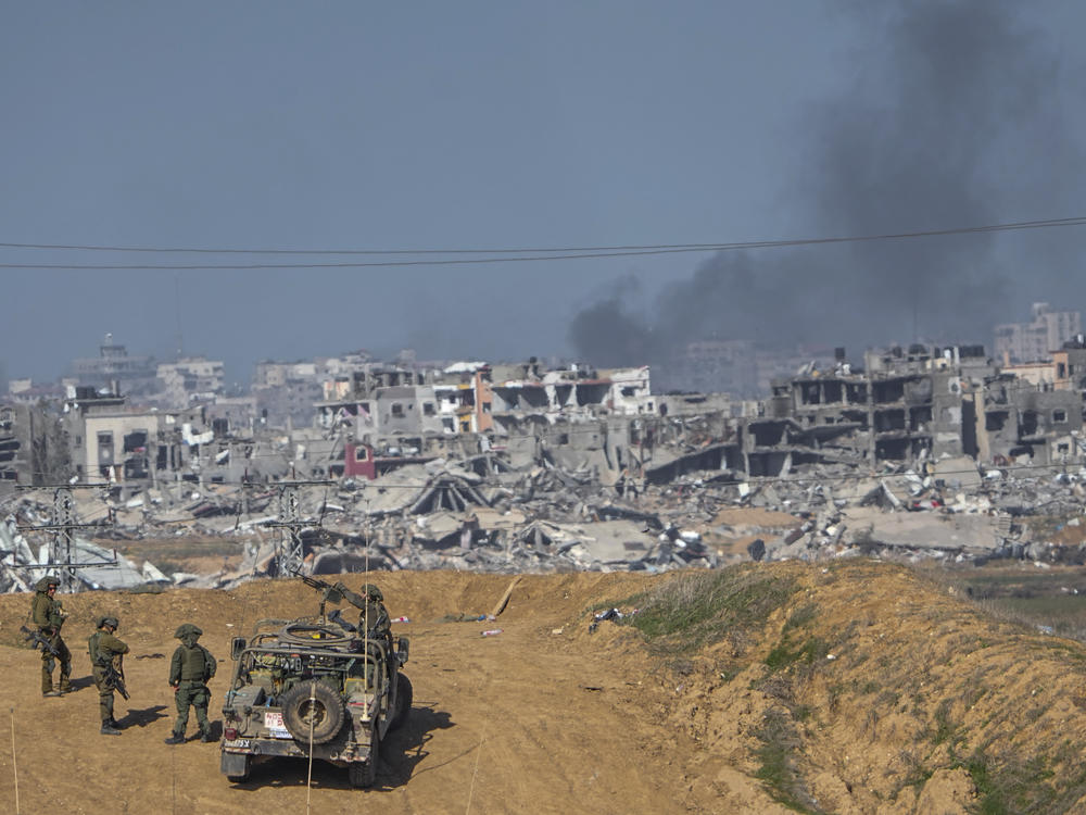 Israeli army troops are seen near the Gaza Strip border, in southern Israel on Sunday.