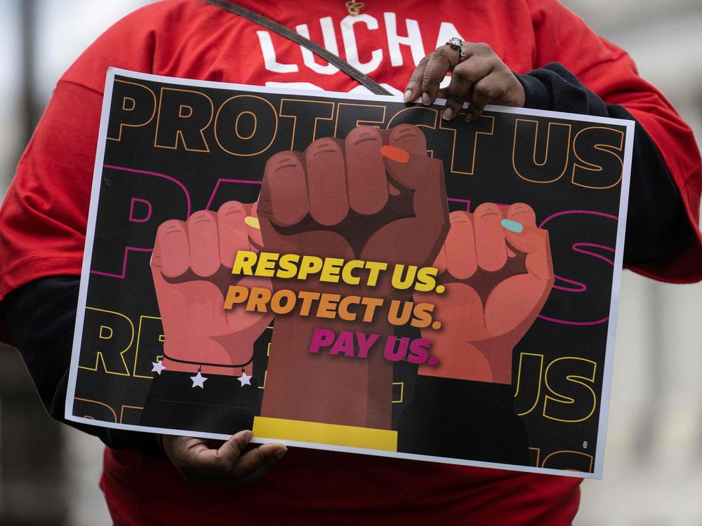 A person holds a sign at a rally to raise the federal minimum wage, on Capitol Hill in Washington, D.C., on May 4.