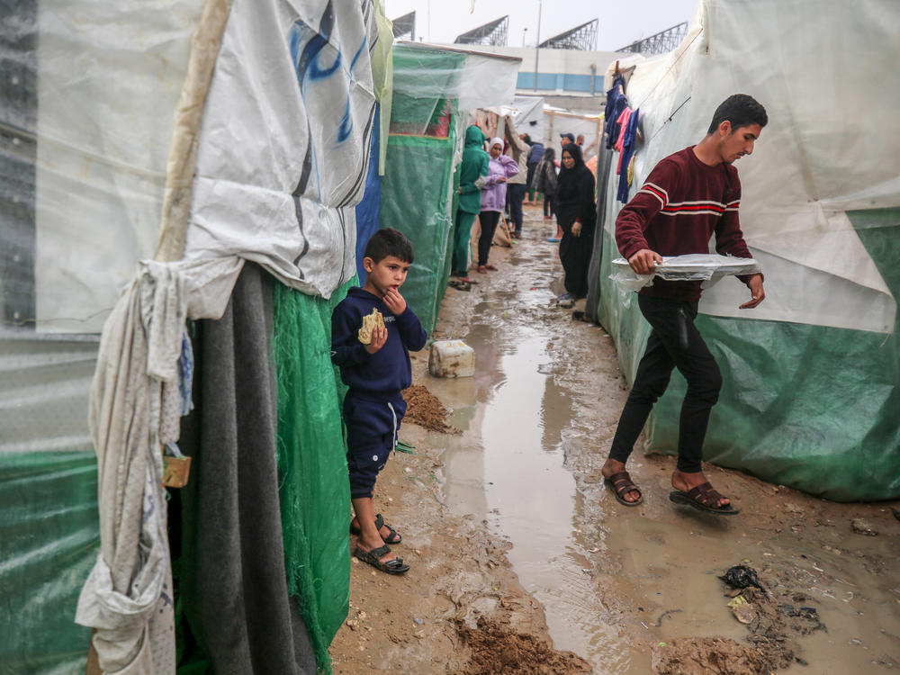 Palestinian children, having fled the Israeli bombing of the northern Gaza Strip in response to the Oct. 7 attack by Hamas, are living in temporary shelters at Al-Aqsa Martyrs Hospital. Global health groups say they are doing what they can to keep a lid on infectious diseases amid crowded, unsanitary conditions and a devastated health-care system.