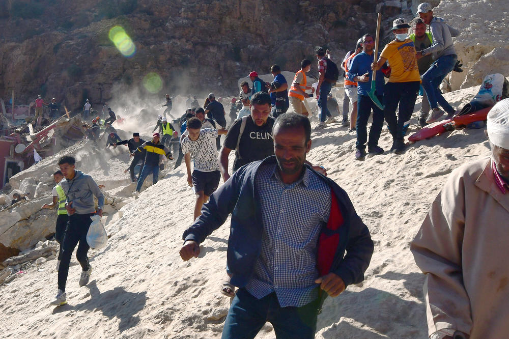 IMI N'TALA, MOROCCO — Civil protection and rescue workers who had been digging out a body from the rubble of a devastating earthquake run in panic during an aftershock in Morocco on Sept. 13. There is danger of more rock falling from the mountain that destroyed the town. <a href=