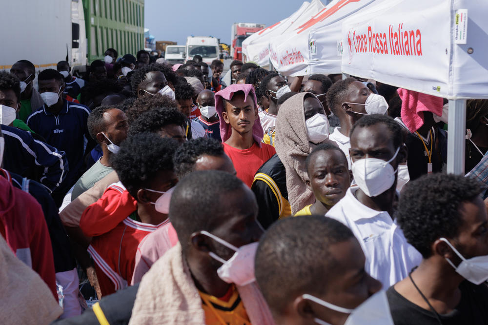 LAMPEDUSA, ITALY — Migrants in Lampedusa's Porto Vecchio wait to be transferred by ferry to Porto Empedocle, from where they will be sent to reception centers across the country, Sept. 22. Most of them arrived during a period when Lampedusa declared a state of emergency due to an influx of about 7,000 migrants in a few days. <a href=