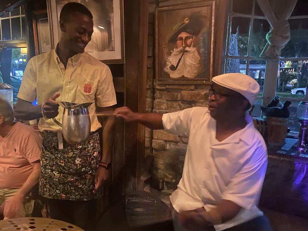 Herlin Riley plays at the Bayou Bar in the Pontchartrain Hotel, and continues his drum solo on waiter Jason Campbell's water pitcher. September, 2023.