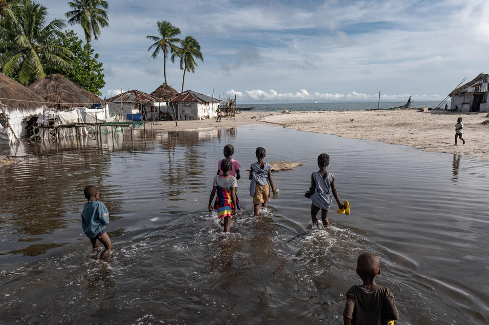Children wade through floodwater on Nyangai Island, Sierra Leone. Most of the island has already been lost to the sea, and what remains is routinely flooded at high tide. Several thousand people once lived here. Now, all but around 400 have fled to higher ground on other islands or the mainland.
