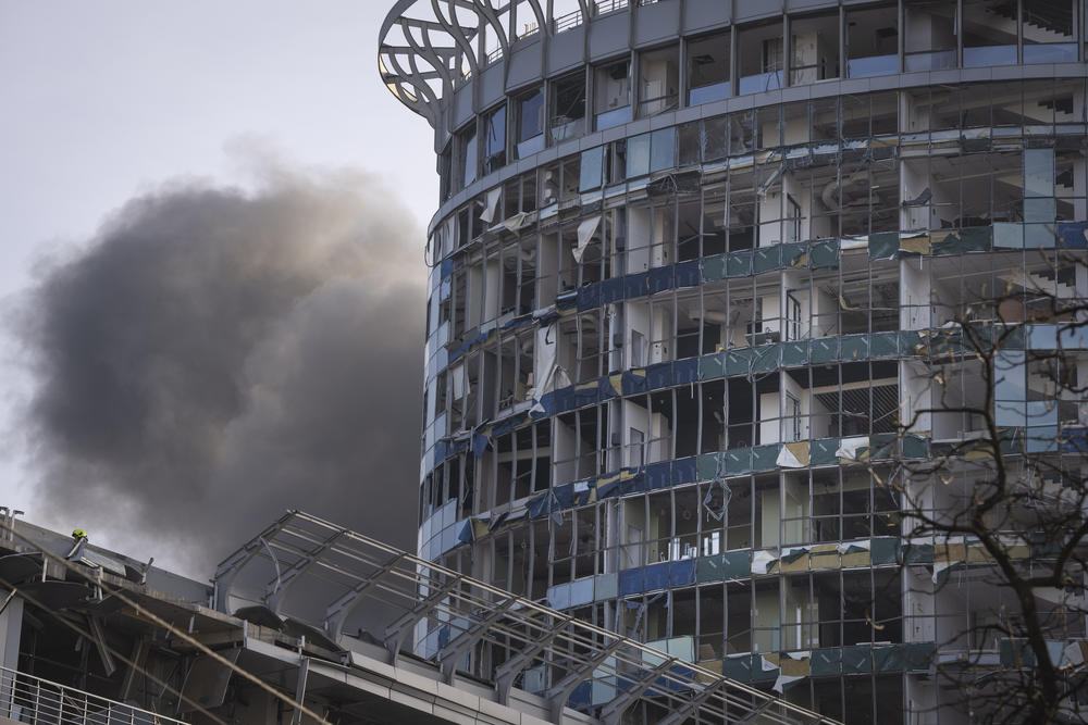 Kyiv: Smoke rises behind a building damaged in Russia's missile attack.