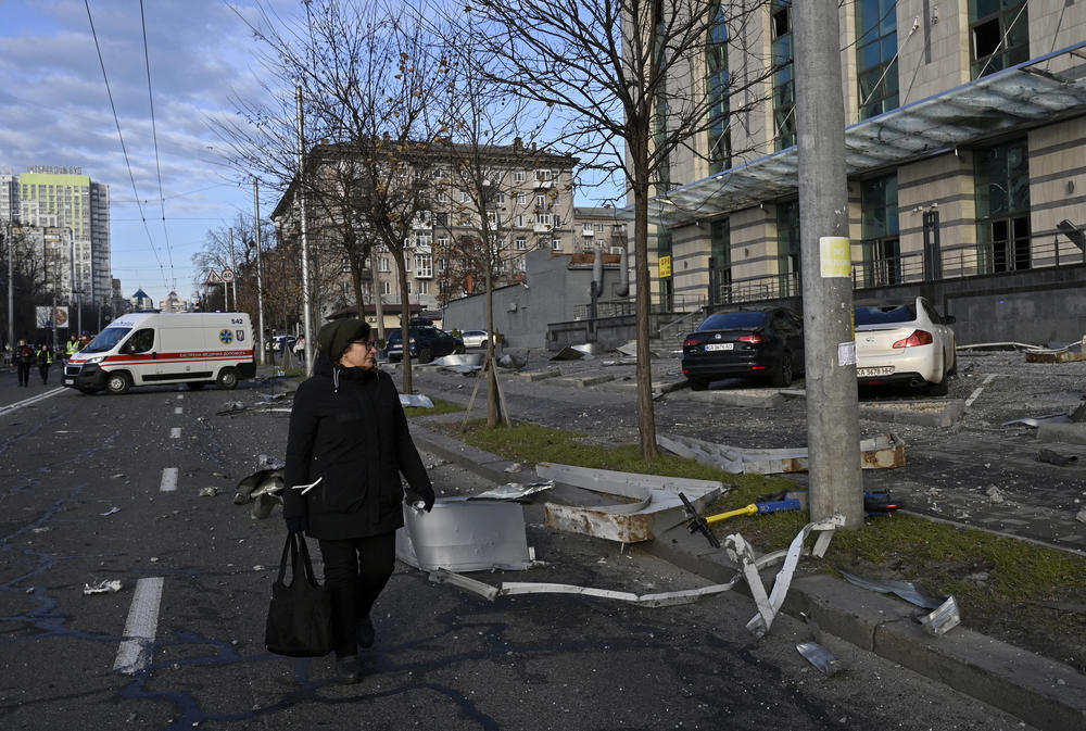 Kyiv: A woman walks past a damaged business centre after a rocket attack.