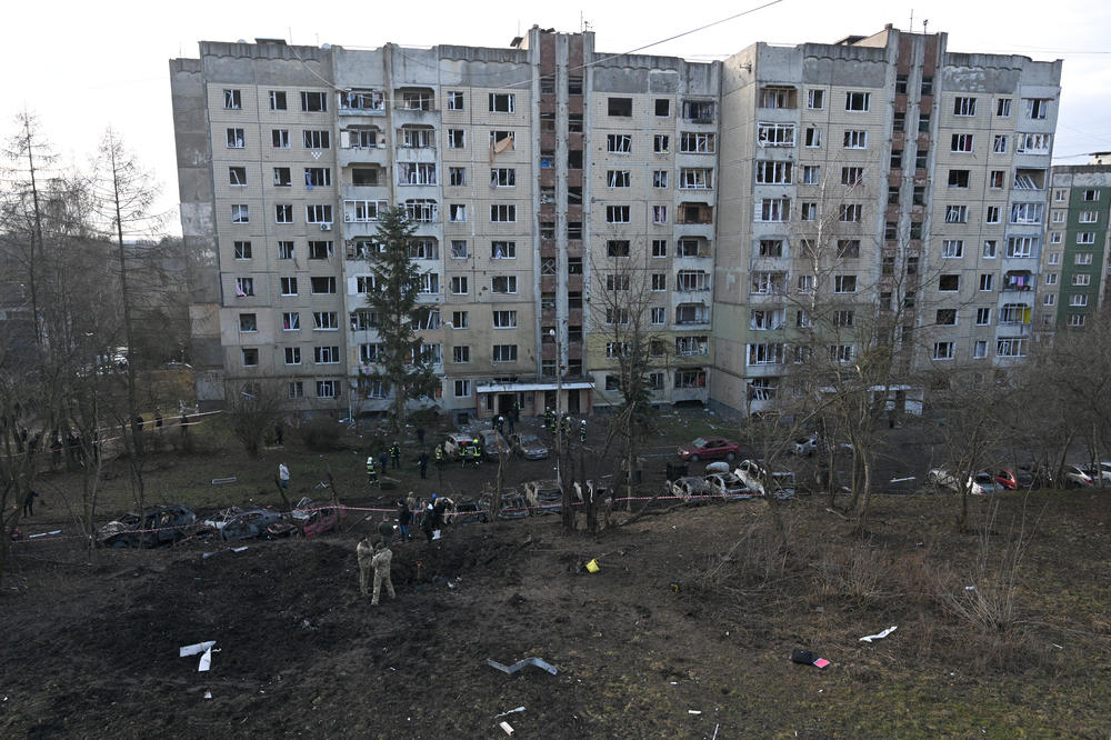Lviv: Ukrainian firefighters and local residents inspect a damaged building and its surroundings.