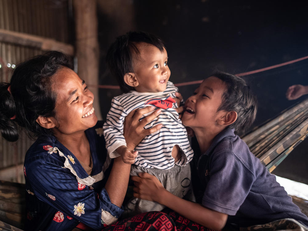 Ten-month-old Ahmin Esas, who was born with clubfoot, shares a moment with his mother and brother in the family's home near Battambang, Cambodia. As a single parent with limited means, his mother, Pho Sok overcame many challenges to ensure her son could receive the treatment he needed.
