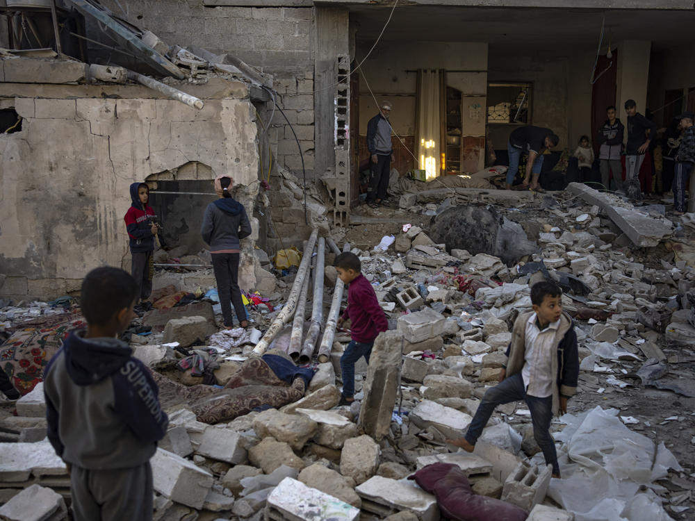 Palestinians look at the destruction after an Israeli strike in Rafah, southern Gaza Strip, on Friday.