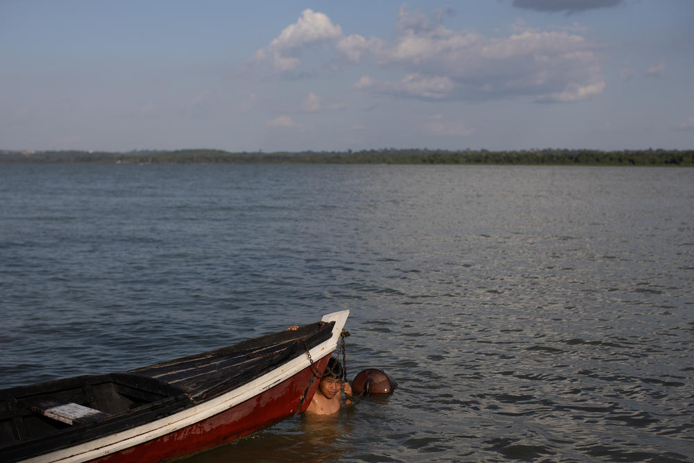 ITAITUBA, BRAZIL — A child plays in a canoe in the waters of the Tapajos River in the indigenous community of the Munduruku ethnic group, Praia do Indio. Indigenous populations in the region suffer from the impact of deforestation and illegal gold mining.