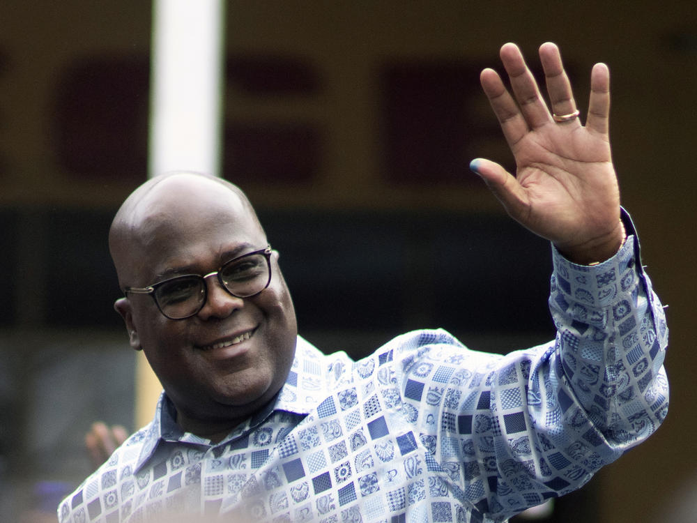 Congo's President Felix Tshisekedi waves to his supporters after casting his ballot inside a polling station during the presidential elections in Kinshasa, Democratic Republic of Congo, Wednesday, Dec. 20, 2023.