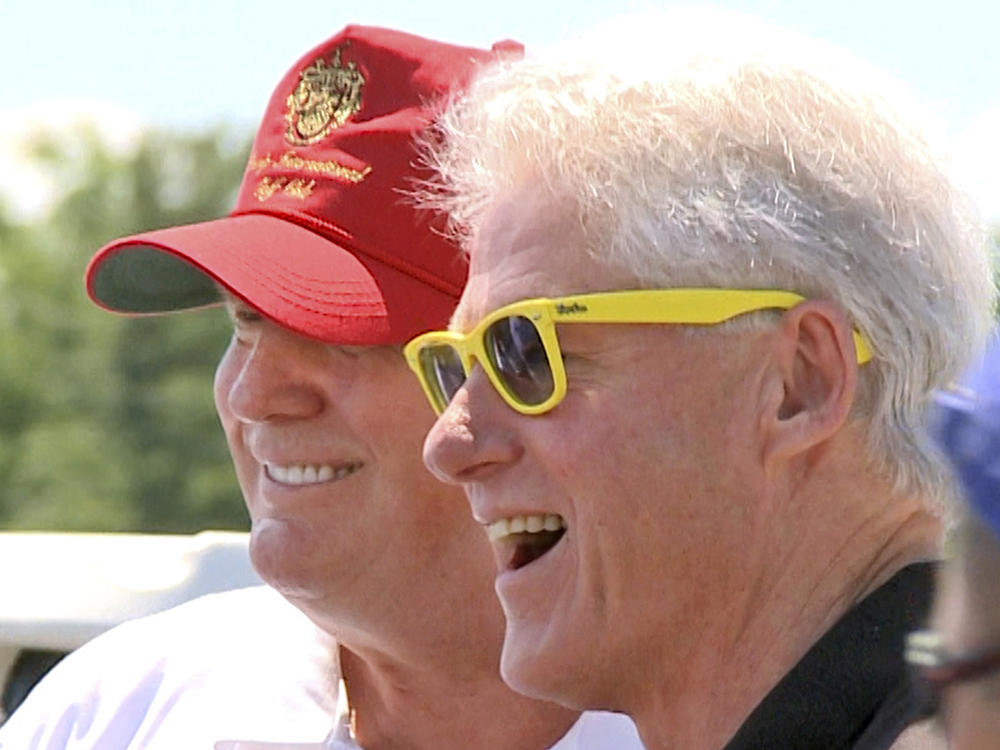 Former Presidents Bill Clinton and Donald Trump pose for photos in New York, July 6, 2009. Both associated with Jeffrey Epstein and have denied any awareness of his criminal activity.