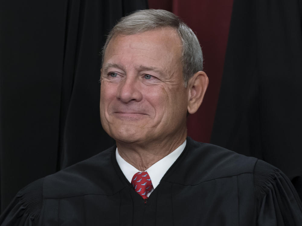 Chief Justice of the United States John Roberts is shown joining other members of the Supreme Court as they pose for a new group portrait, at the Supreme Court building in Washington, Friday, Oct. 7, 2022.