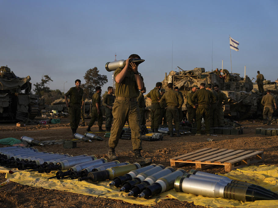 Israeli soldiers load shells onto a tank Sunday at a staging area in southern Israel near the border with Gaza. The army is battling Palestinian militants across Gaza in the war ignited by Hamas' Oct. 7 attack into Israel.