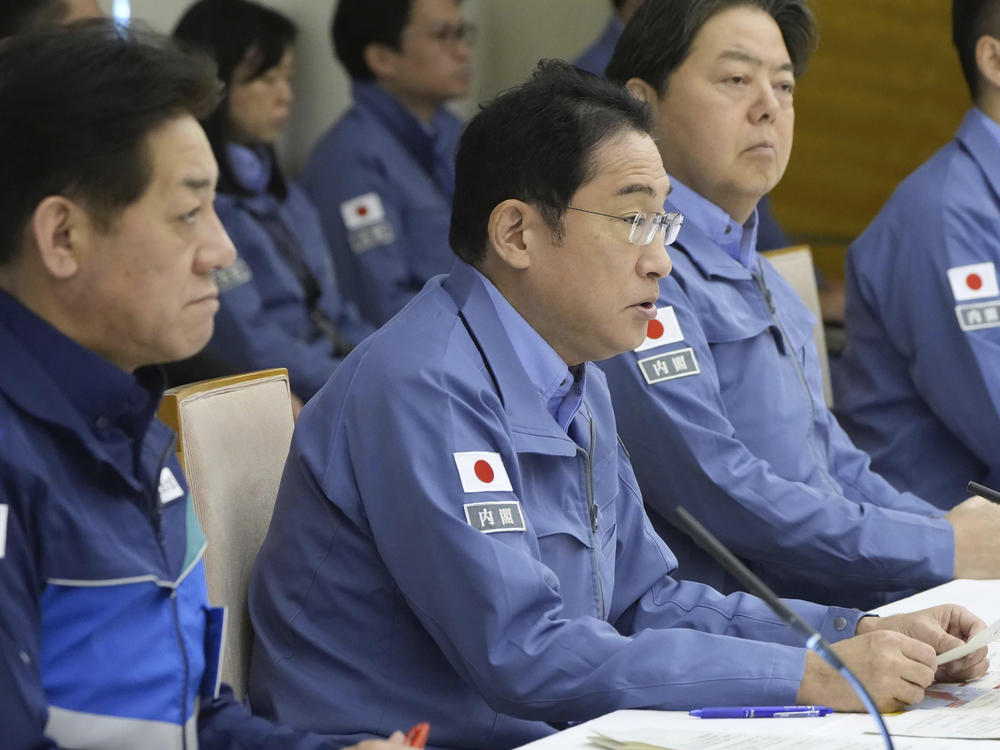 Japan's Prime Minister Fumio Kishida, second from left, speaks at a disaster response meeting at his office in Tokyo Tuesday, Jan. 2, 2024.