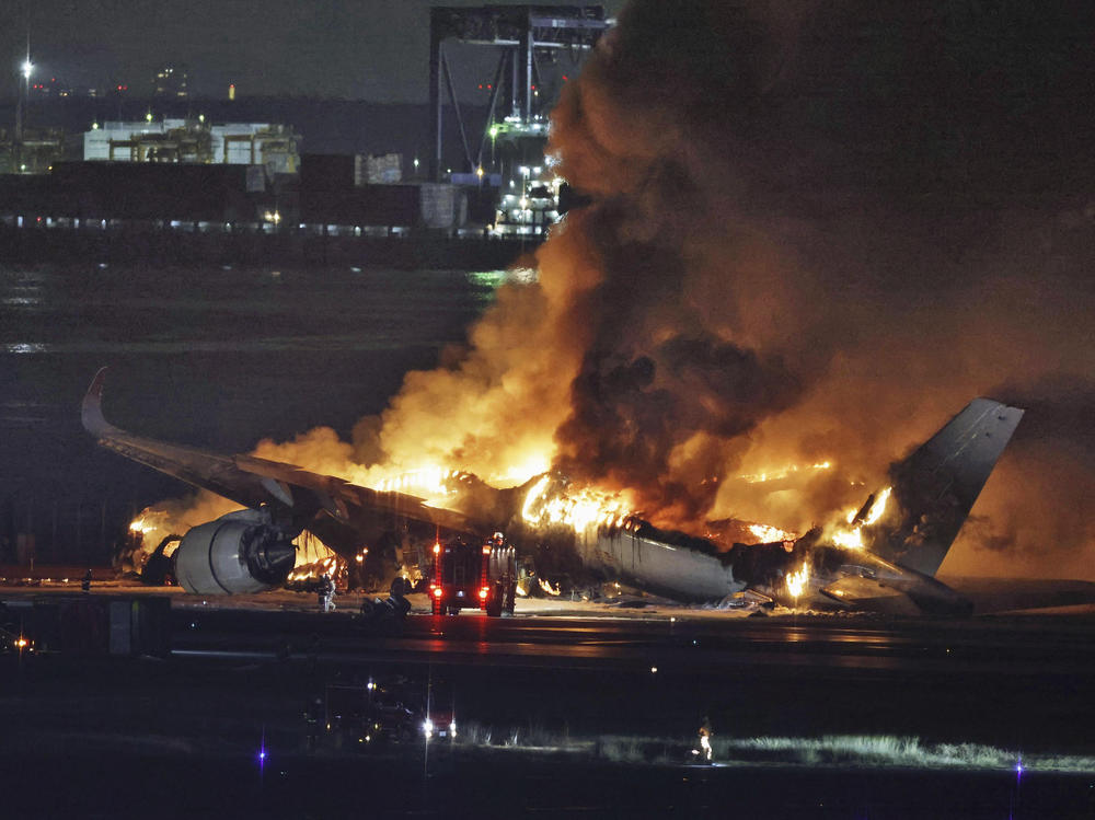 A Japan Airlines plane is on fire on the runway of Haneda airport on Tuesday in Tokyo.