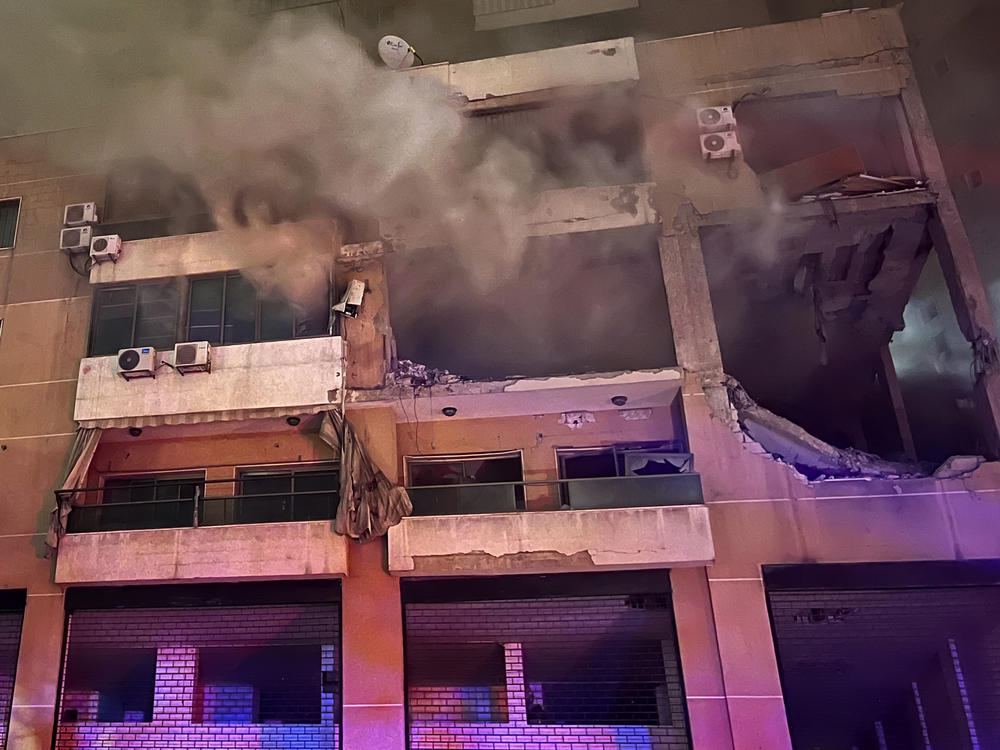 Smoke rises from a destroyed apartment following a large explosion in a southern suburb of Beirut on Tuesday. The TV station of Lebanon's Hezbollah group says top Hamas official Saleh Arouri was killed Tuesday in an explosion in a southern Beirut suburb.