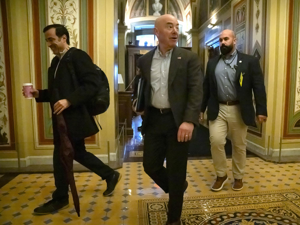 Homeland Security Secretary Alejandro Mayorkas, center, arrives at the U.S. Capitol on Dec. 17 for negotiations on a border security deal.