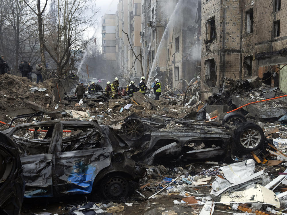 Firefighters work to extinguish a fire in a destroyed apartment building after a Russian attack in Kyiv, Ukraine, on Tuesday.
