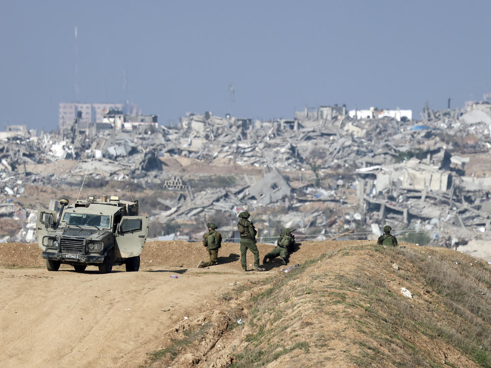 Israeli soldiers overlooking Gaza City on Monday.