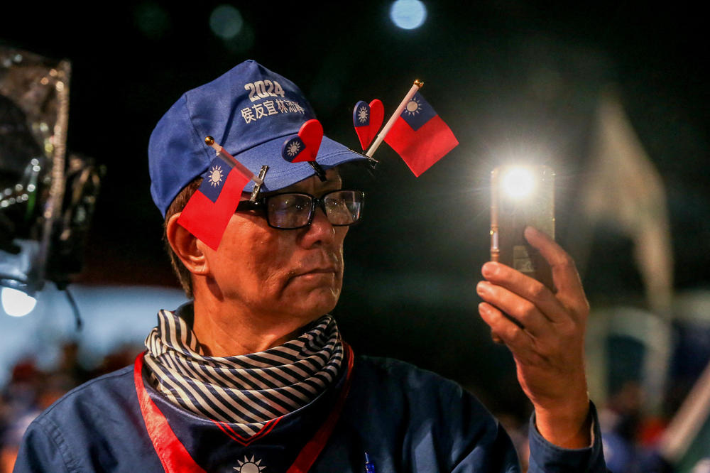 A supporter wears small Taiwan national flags on his hat during an election campaign rally of Kuomintang (KMT) on January 4.