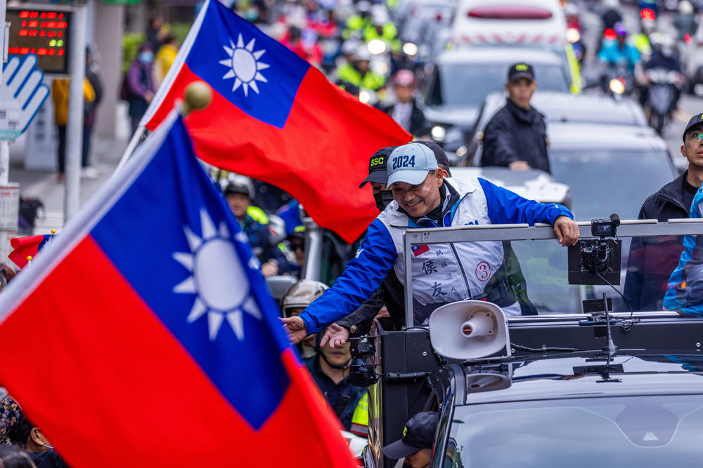 KMT presidential candidate Hou Yu-ih shakes hands with supporters during an election campaign on January 4.