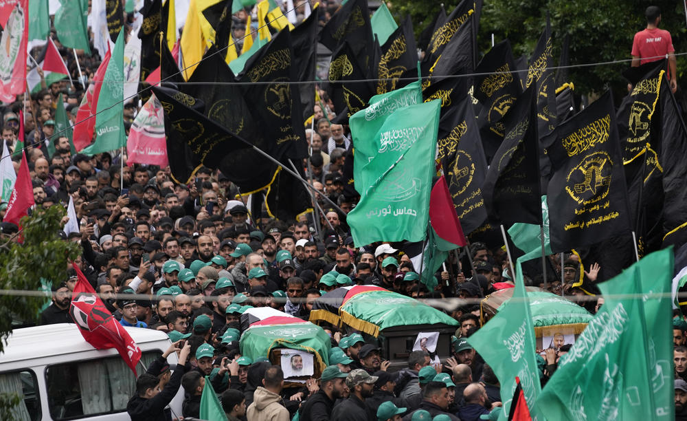 Mourners carry the coffins of Saleh Arouri, a senior Hamas commander, and two other Hamas members, who were killed in an airstrike on Tuesday in Beirut, Lebanon. Hamas blames Israel for the attack.